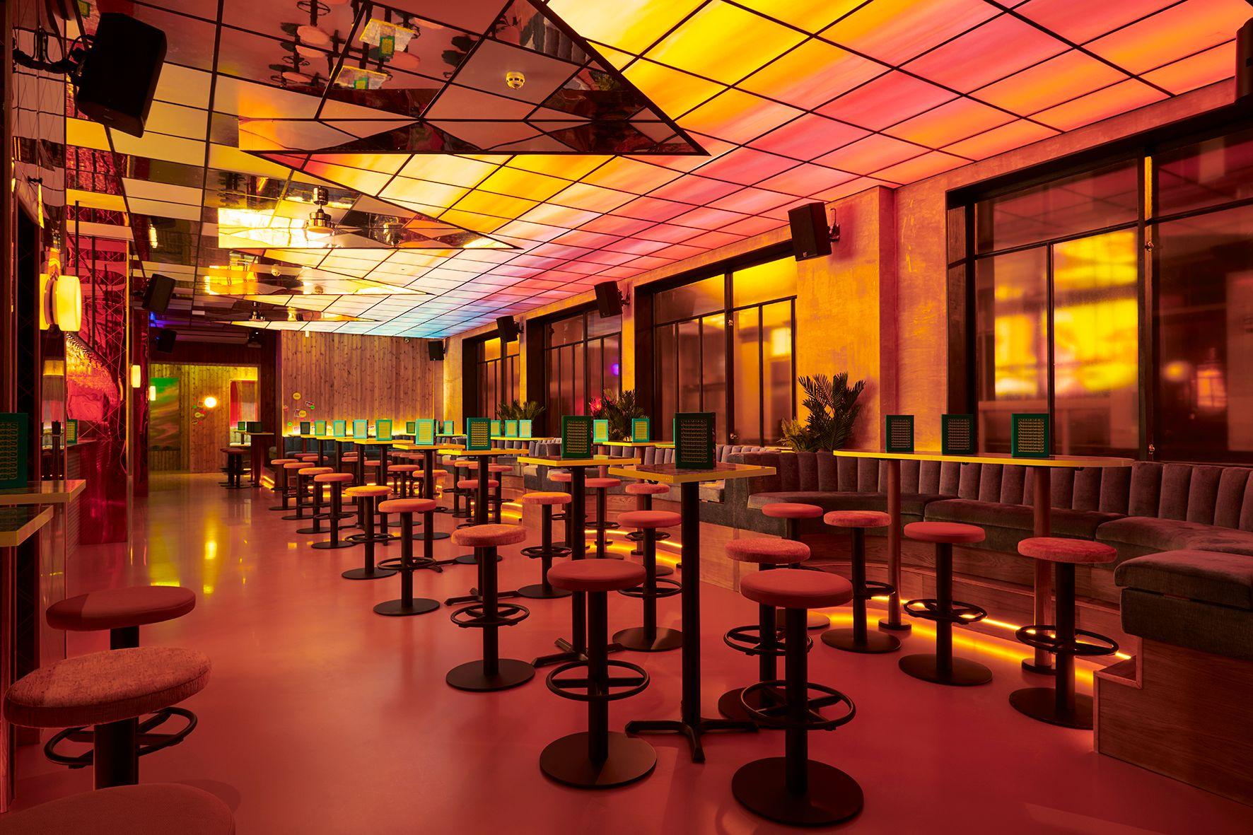 Bar area with high tables and stool seating with a sunset roof.